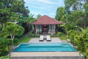 a villa with a swimming pool and a house at Banyan Tree Lang Co in Hue