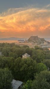 a view of a city with a hill in the distance at Liston Suites Anastasia in Corfu Town
