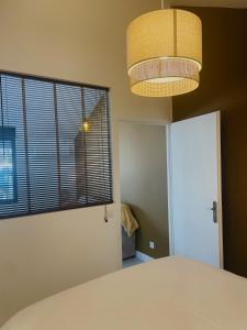 a bedroom with a bed and a large window at Les Casas de Sísi in Chassieu
