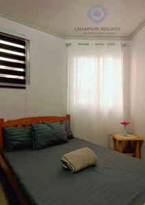 a bedroom with a bed with a pillow on it at Spacious modern home near town in Baguio