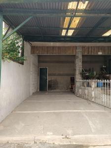 an empty parking garage with a green door at Spacious modern home near town in Baguio