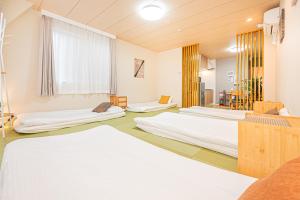 a room with three beds and a window at Mori hotel Akihabara 1 in Tokyo