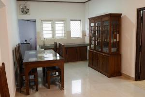 a kitchen with a wooden table and a sink at Minhas Villas Guest in Kamburugamuwa