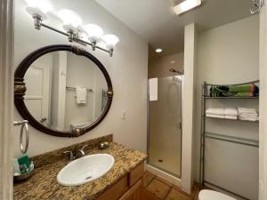 a bathroom with a sink and a mirror at Beso Del Sol in Huntington Beach