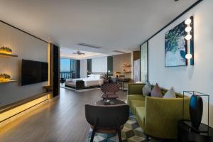 a living room with a couch and a bed at Sanya Golden Phoenix Seaview Hotel in Sanya
