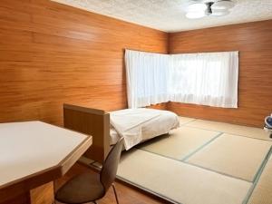 Postel nebo postele na pokoji v ubytování Ocean Kushima Rakuda no Yado