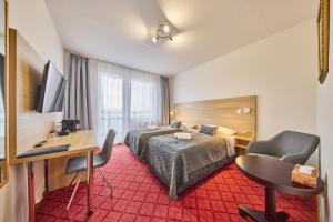 Postel nebo postele na pokoji v ubytování PATRIA HOTEL
