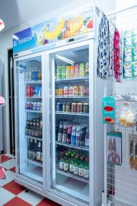 a refrigerator filled with lots of drinks in a store at Palace Suite Residence in Phnom Penh