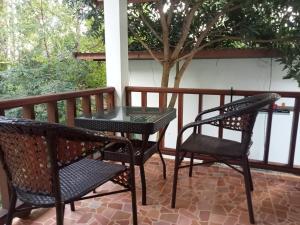 two chairs and a table on a patio at KPG Baan Tai 2 in Ban Tai