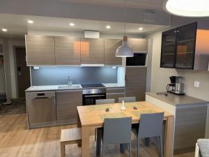 a kitchen with a wooden table and a dining room at Ylläs Chalets IV 4204 in Ylläsjärvi