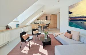 a living room with a blue couch and chairs at Style pur - Designer-Wohnung in Top-Lage! - Bis zu 3 Personen - Wittlich - Zetrum in Wittlich