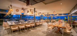 a restaurant with tables and chairs and a bar at Delphin Imperial Lara in Lara