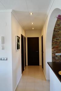 a hallway of a house with a black door at Laguna del Flamenco in Torrevieja