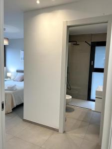 a bedroom with a bed and a bathroom with a toilet at Locarno Center - Casa Incanto - Free Parking & Washer in Locarno +17 photos