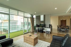 a living room with a couch and a table at Family Only Spacious Hill View Villa - De Reiz Zakir Syariah 5BR in Ciburial