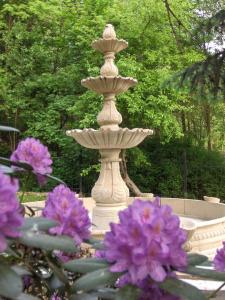 a fountain in the middle of a garden at Romantic Chateau Krasna Lipa in Krásná Lípa