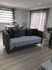 a couch sitting in a living room at Family friendly home in a cul-de-sac! in Muizenberg