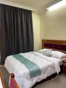 a bedroom with a large bed with a window at SURIA HOTEL SDN BHD in Kota Bharu
