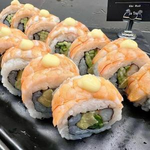 a bunch of sushi sitting on top of a table at 12 The Residence Hotel at Don Mueang Airport in Bangkok