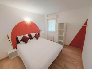 a bedroom with a large white bed with a red headboard at Cosy 3 - Audincourt centre in Audincourt