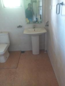 a bathroom with a sink and a toilet at Rose Villa in Kurunegala