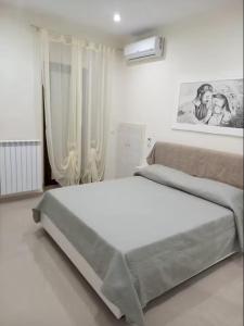 Postel nebo postele na pokoji v ubytování Il Sorriso Casa Vacanze