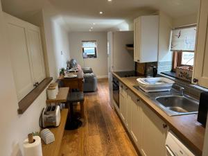 a kitchen with a sink and a counter top at The Stable -Plymouth in Plymouth