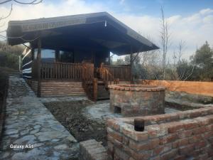 a house with a large deck and a brick wall at Ali dede in Kusadası