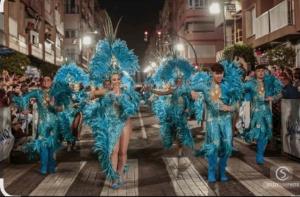 a group of women in blue costumes walking down a street at Apartamento céntrico cerca de la playa I in Águilas