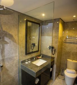 a bathroom with a sink and a shower at Hotel Suni Abepura in Tobadi +2 photos