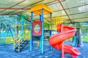 a playground with a colorful slide and a slide at Asfar Resorts Al Ain in Al Ain