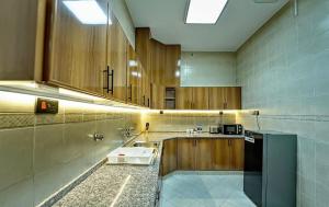 a large kitchen with a sink and a counter at Asfar Resorts Al Ain in Al Ain