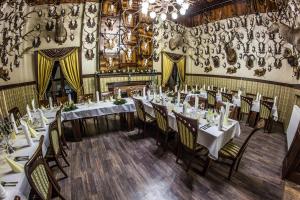 a dining room with white tables and chairs at Penzión Altmayer in Banská Štiavnica