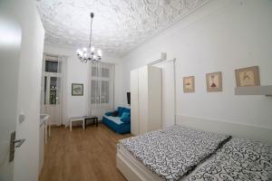 プラハにあるアパートメンツ カタリーナの白いベッドルーム(ベッド1台、青いソファ付) +34枚の写真