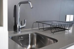 a metal wire basket sitting on a kitchen sink at Bridgewater Studio Century City in Century City