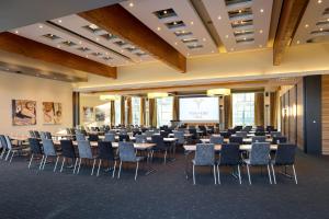 a conference room with tables and chairs and a screen at Best Western Premier Park Hotel & Spa in Bad Lippspringe +106 photos