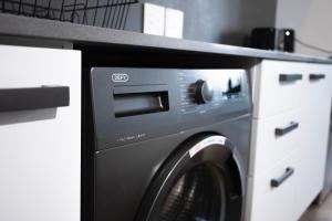 a washer and dryer with a counter above it at Bridgewater Studio Century City in Century City +12 photos