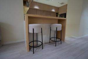two bar stools in a kitchen with a counter at Latifa Housing in Riyadh +4 photos