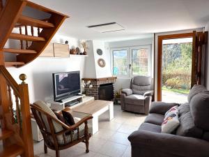 a living room with a couch and a tv at casa rural cobreces in Cóbreces
