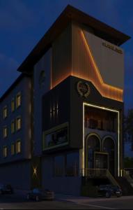 a hotel building with a car parked in front of it at Ringus Luxury Line in Mughal Sarāi