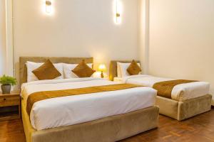Postel nebo postele na pokoji v ubytování Mhendo Hotel & Studio Suites