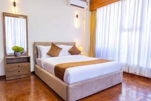 Postel nebo postele na pokoji v ubytování Mhendo Hotel & Studio Suites