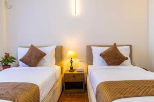 Postel nebo postele na pokoji v ubytování Mhendo Hotel & Studio Suites