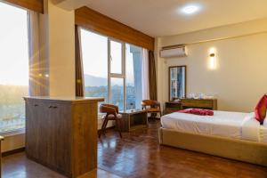 Postel nebo postele na pokoji v ubytování Mhendo Hotel & Studio Suites