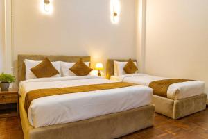 Postel nebo postele na pokoji v ubytování Mhendo Hotel & Studio Suites