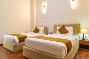 Postel nebo postele na pokoji v ubytování Mhendo Hotel & Studio Suites