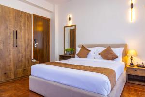 Postel nebo postele na pokoji v ubytování Mhendo Hotel & Studio Suites