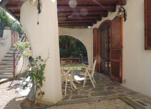 a patio with a table and chairs in a house at Villetta Elena Via Loreto 64 villa 14 in Marcelli