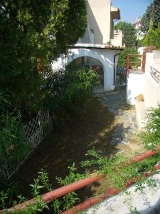 a walkway leading to a house with a bridge at Villetta Elena Via Loreto 64 villa 14 in Marcelli +3 photos