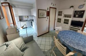 a living room with a table and a kitchen at Villetta Elena Via Loreto 64 villa 14 in Marcelli